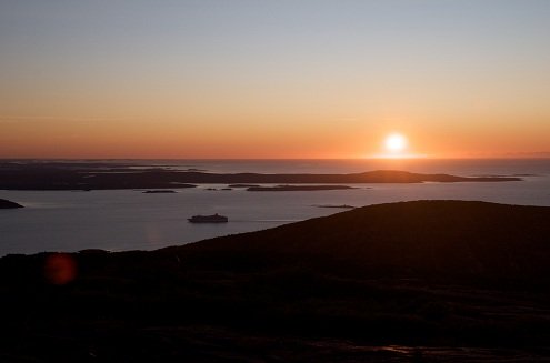 white sun sunset over water