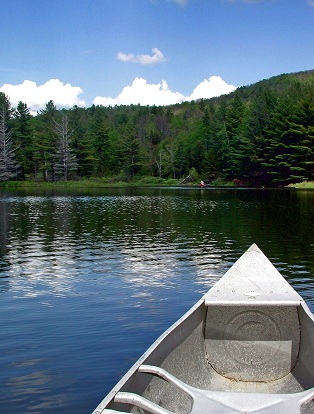 boat on lake by mountains