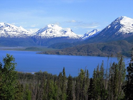 bright blue water surrounded by mountains