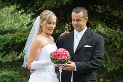 bride, groom holding bridal bouquet