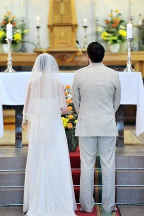 bride and groom at altar