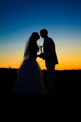 newlyweds at sunset