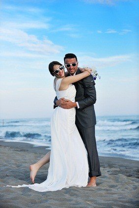 bride and groom on sand beach