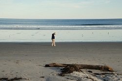 person walking by lake