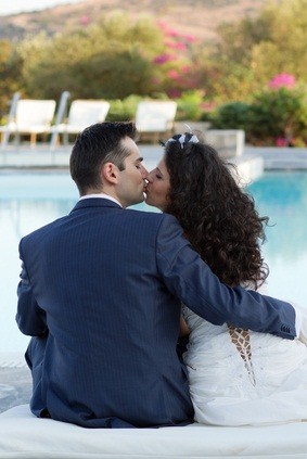 newlywed kiss by pool