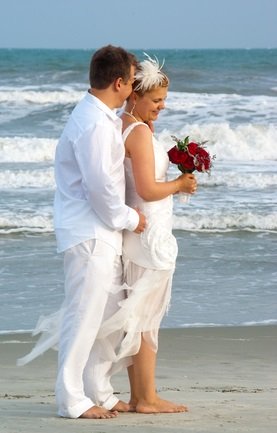 bride and groom by ocean